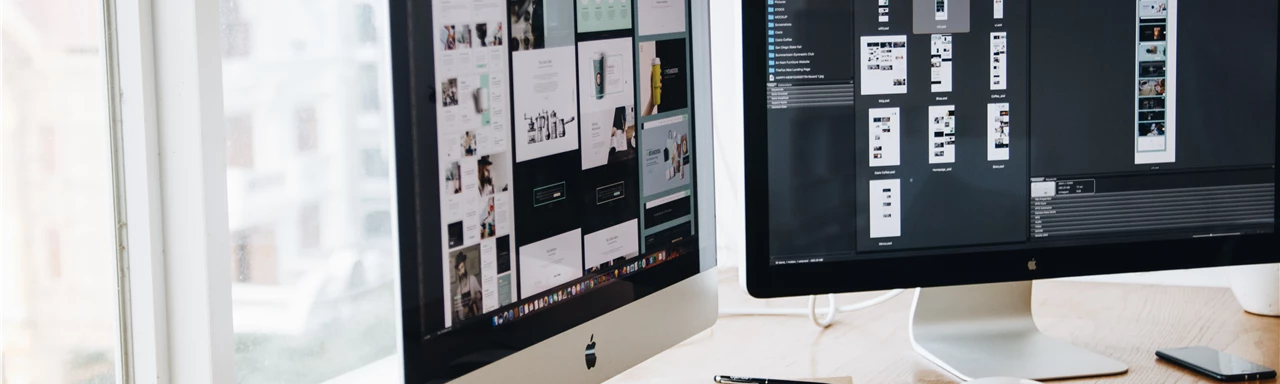 Silver Imac on Top of Brown Wooden Table