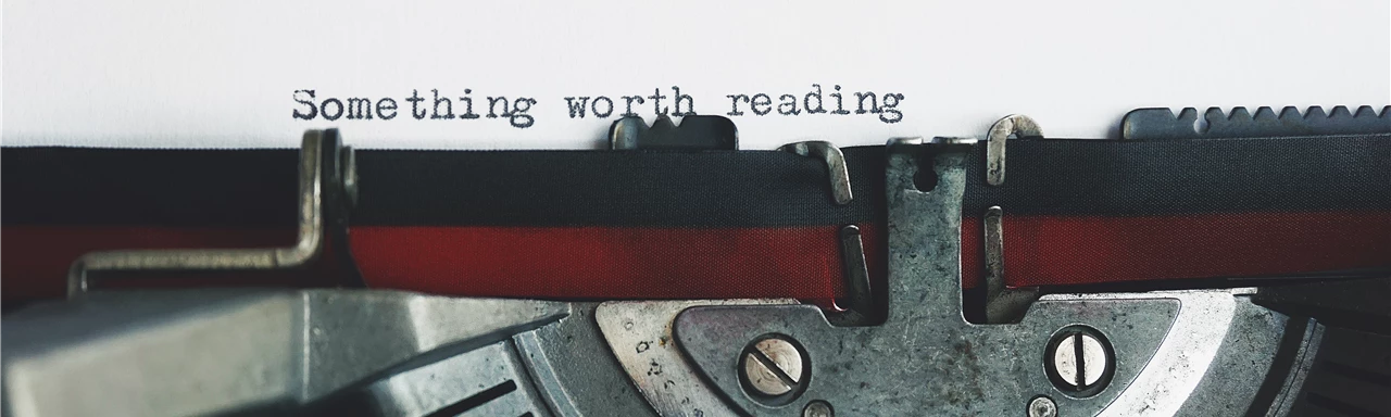 Black and Red Typewriter on White Table