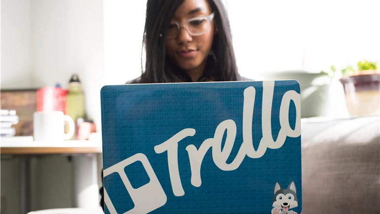 Woman Wearing Eyeglasses Using Blue and and Gray Laptop Inside Room