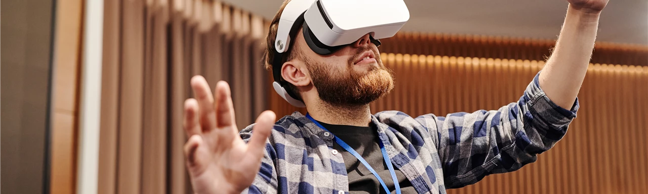 Man Wearing Virtual Reality Headset Raising His Hands